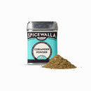 A tin of Spicewalla Coriander Powder by Spicewalla stands upright on a white background, with a small pile of this citrusy spice in front—ideal for adding flavor to savory dishes.