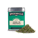 A green tin of Spicewalla Herbs de Provence by Spicewalla, containing 0.8 oz (23 g) of classic French herb blend for roasting, sits beside a small pile of dried mixed herbs.