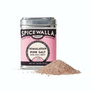 A Spicewalla Himalayan Pink Salt Extra Small Grain tin is placed beside a small mound of pink salt crystals, all on a white background.