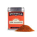 A tin of Spicewalla Jerk Seasoning by Spicewalla is shown beside a small pile of reddish-brown seasoning. The tin features a red and orange label with black and white text.