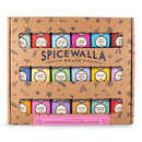 The Spicewalla Kitchen Essentials 18-Pack Collection by Spicewalla features 18 colorful spice tins, visible through a windowed box and labeled with names like onion powder, paprika, thyme, and rosemary.