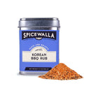 A 3.7-ounce (106 g) blue-labeled tin of Spicewalla Korean BBQ Rub sits next to a pile of the orange-brown seasoning, ideal for grilled meats or classic Korean BBQ dishes.