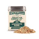 A cream-colored tin of Spicewalla Mignonette Blend for Seafood sits beside a small pile of seasoning, its green accents and Island Creek Oysters collaboration noted—ideal as a topping for oysters or as a flavorful seafood seasoning.