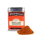 A tin of Spicewalla Mom's Taco Seasoning by Spicewalla sits with a small pile of reddish-brown seasoning powder in front, ideal for adding bold homemade taco flavor to your favorite dishes.