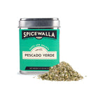 A teal tin labeled Spicewalla Pescado Verde Seafood Seasoning by Spicewalla sits beside a small mound of its vibrant green and white citrus herb blend. The metallic-lidded tin holds 2.3 oz (65 g) of zesty seafood seasoning.