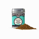 A tin of Spicewalla Roasted Cumin Powder, featuring a teal and black design, sits beside cumin powder, adding bold toasted flavor to your spice collection.