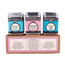 The Spicewalla Salt Collection 3 Pack by Spicewalla features Sicilian Sea Salt, Himalayan Pink Salt, and Mediterranean Flake Salt in three tins, displayed on a brown box with descriptions of each specialty finishing salt underneath.