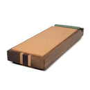 The Folded Steel Stropping Block features a natural leather strop on a hardwood base with decorative inlays, plus a green honing compound bar—ideal for achieving razor-sharp knife edges.