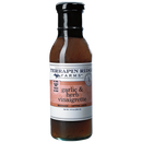 A bottle of Terrapin Ridge Farms Garlic & Herb Vinaigrette—a vegan salad dressing with a brown liquid, black cap, and pink label—ideal as roasted garlic dressing or marinade.
