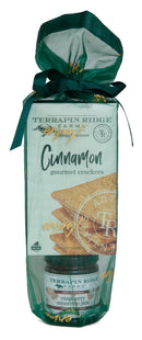 The Terrapin Ridge Farms Holiday Grab and Go Giftset pairs cinnamon crackers with raspberry amaretto jam in festive green packaging with a ribbon—a delightful treat for any occasion.