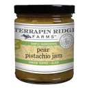 A glass jar of Terrapin Ridge Farms Pear Pistachio Jam with a black lid, featuring visible small pieces. Labeled as a cheese topper and glaze, it’s ideal for appetizers or charcuterie boards. Gluten free and vegan.