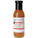 A clear glass bottle of Terrapin Ridge Farms Pineapple and Habanero Sauce with a black cap and white label shows the sauce’s vibrant orange color. This sweet and spicy condiment is made by Terrapin Ridge Farms.