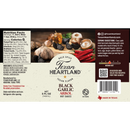 Texan Heartland Black Garlic Arbol Hot Sauce label highlights black garlic, fresh garlic, Chile de Árbol peppers, and spices. Features nutrition facts, ingredients list, a medium-hot heat meter, and Texan Heartland's social media details.