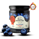 Texan Heartland Blueberry Royale Jam is shown with fresh blueberries. The label features Grand Marnier liqueur, and an award badge is visible in the top right corner.
