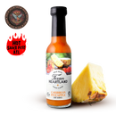 A bottle of Texan Heartland Caribbean Pineapple Hot Sauce stands next to a pineapple wedge, with the Hot Sauce Fest ATL flame logo and a 3rd Place NYC medallion displayed on a white background.