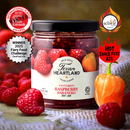 A jar of Texan Heartland Cinnamon Raspberry Habanero Hot Jam is displayed with fresh raspberries and a habanero pepper, while award badges and bold text highlight its wins at international and hot sauce competitions.