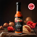 A bottle of Texan Heartland Roasted Onion & Garlic Reaper Hot Sauce sits on a wooden surface with onions, red chili, garlic, and a taco. The International Flavor Awards badge is displayed in the top right corner.