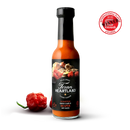 A bottle of Texan Heartland Roasted Onion & Garlic Reaper Hot Sauce stands beside a red pepper. The label features roasted onion and garlic, with an International Flavor Awards seal in the top right corner.