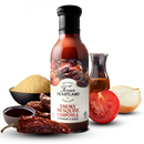 A bottle of Texan Heartland Smoky Mesquite Chipotle Marinade & Sauce is surrounded by dried chipotle peppers, brown sugar, tomato slices, a half onion, oil, and a bowl of sauce—delivering bold Texas BBQ flavor.