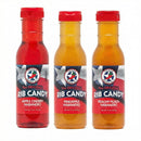 The Texas Pepper Jelly Sweet Heat BBQ Gift Box includes three bottles of habanero BBQ sauce—Apple Cherry, Pineapple, and Peachy Peach flavors—all with red caps and patriotic labels; an ideal gift for spice lovers.