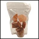 Texas Salt Co. Himalayan Pink Salt Rocks come in a clear, resealable pouch with a white label, featuring large, raw pink salt chunks—ideal for those who want natural mineral salt from Texas Salt Co. for cooking or seasoning.