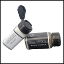 The Texas Salt Co. Salt & Pepper Set features sea salt with an open lid and black pepper on a white background with a black border—ideal for everyday seasoning.