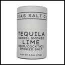 A cylindrical container of Texas Salt Co. Tequila Barrel Smoked Lime Beer & Cocktail Salt, ideal for rimming beers or cocktails, Net Wt 2.5oz (71g), shown against a white background.