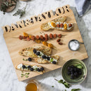 The Words With Boards Large Personalized Cutting Board by Words with Boards, LLC (12.5" x 16") displays crostini with blackberries, goat cheese, and herbs, skewers of cherry and sun-dried tomatoes, plus a bowl of blackberries and honey.