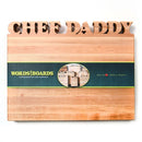 A Words With Boards Large Personalized Cutting Board (12.5" x 16") by Words with Boards, LLC, engraved with CHEF DADDY at the top, comes wrapped in a green WORDS BOARDS label with a heart logo and Baltimore, Maryland reference.