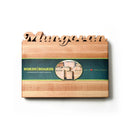 The Words With Boards Personalized Cutting Board Small (9.5" x 12.5") by Words with Boards, LLC features a custom name cutout, light hardwood finish, heart symbol for Maryland-made, and comes in green packaging—a unique kitchen gift.