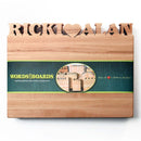 The Words With Boards Personalized Cutting Board (Small, 9.5" x 12.5") by Words with Boards, LLC makes a perfect kitchen gift for couples, featuring custom names cut out at the top and a green band labeled WORDS with BOARDS.