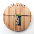 The Words With Boards Seriously Gluten Free Round Personalized Cutting Board (14" diameter) by Words with Boards, LLC features “JANET” cut out at the top and “Seriously GLUTEN FREE” engraved below, plus a green branded tag tied with twine. Perfect for gluten free use!.