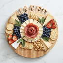 The 14" Words With Boards Seriously Gluten Free Round Personalized Cutting Board by Words with Boards, LLC features "JANET" spelled in cheese, surrounded by crackers, cheese wedges, fruit, hazelnuts, and a salami rose. "Seriously GLUTEN FREE" is engraved.