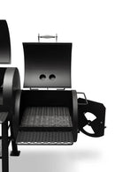 A close-up of the Yoder Smokers Durango 20 Offset Smoker by Yoder Smokers shows its open firebox with an interior grate and adjustable air vent. This large-capacity black metal BBQ is set against a white background.