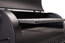 Close-up of the black metal interior of the Yoder Smokers Loaded Wichita Offset Smoker, featuring two mesh cooking racks stacked inside and a partially open lid—highlighting American-made quality from Yoder Smokers.