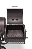 A close-up of the Yoder Smokers Loaded Wichita Offset Smoker by Yoder Smokers, made in the USA, with its black metal lid open to reveal a metal grate, two round vents on the lid, and a matching stand featuring a mesh shelf below.