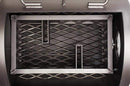 Top view of the Yoder Smokers Loaded Wichita Offset Smoker firebox, featuring a heavy-duty expanded metal charcoal basket with dividers for efficient airflow and heat distribution. The clean, industrial interior highlights Yoder Smokers' quality craftsmanship.