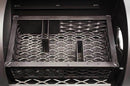 A close-up inside the Yoder Smokers Loaded Wichita Offset Smoker shows a sturdy black grated metal tray with wavy surfaces and thick divider bars, showcasing Yoder Smokers’ trusted American craftsmanship.