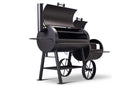 The Yoder Smokers Loaded Wichita Offset Smoker features a black barrel design, chimney, two doors with cooking grates, large wheels, and a side firebox for indirect heat. Proudly made in the USA by Yoder Smokers.