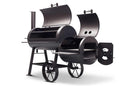 The Yoder Smokers Loaded Wichita Offset Smoker is a black metal, American-made grill with two chambers and interior grates. It features a side firebox with a circular vent and wheels for portability.