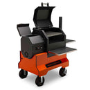 The Yoder Smokers YS480S Competition Pellet Grill with Stainless Steel Shelves features a chimney, multiple compartments, metal side shelves, sturdy wheels for mobility, and an open main lid showcasing grill grates ideal for direct-flame grilling.