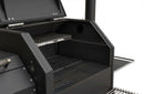 Close-up of an open Yoder Smokers YS480S Competition Pellet Grill with stainless steel shelves, featuring two clean cooking racks—a main lower grate and an elevated upper grate. All interior and metal surfaces appear unused.