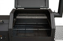 Open the Yoder Smokers YS480S Competition Pellet Grill with stainless steel shelves to reveal an empty cooking chamber, two metal racks, and a right-side smoke chimney—designed for competition-ready pellet grilling and direct-flame performance.