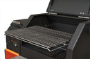 A close-up of a partially open Yoder Smokers YS480S Competition Pellet Grill with Stainless Steel Shelves shows the control panel, raised warming rack, and cooking grates designed for direct-flame grilling. Brand: Yoder Smokers.