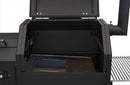 Open lid of a black Yoder Smokers YS480S Competition Pellet Grill with Stainless Steel Shelves, showing the empty cooking chamber with grill racks removed and metal drip tray visible, ready for direct-flame grilling.