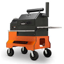 The Yoder Smokers YS480S Competition Pellet Grill by Yoder Smokers features a modern rectangular design, stainless steel shelves, four large wheels, a chimney, and handles and vents for temperature or direct-flame grilling control.