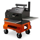 The Yoder Smokers YS480S Competition Pellet Grill features stainless steel shelves, a front door, digital display, four large wheels for mobility, and direct-flame grilling capability.