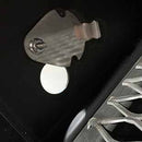 Close-up of the metal igniter electrode and white ceramic insulator inside a Yoder Smokers YS640S Competition Pellet Grill with Wire Shelves, featuring part of the metal cooking grate—ready to deliver authentic wood-fired flavor.