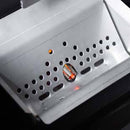 Close-up of a metallic container with round holes and a central vent, part of the Yoder Smokers YS640S Competition Pellet Grill with Wire Shelves, with a faint orange glow hinting at wood-fired cooking.