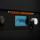 Close-up of a Yoder Smokers YS640S Competition Pellet Grill with Wire Shelves control panel, featuring the orange Yoder Smokers label, power and function buttons, display screen showing "YS," and large silver knob—ideal for wood-fired flavor mastery.